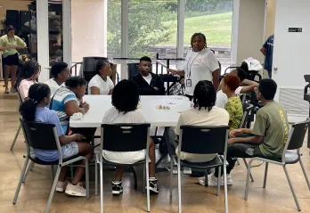 Teens sitting around a table learning about Mental Health