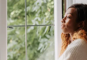 Woman look thoughtfully out the window