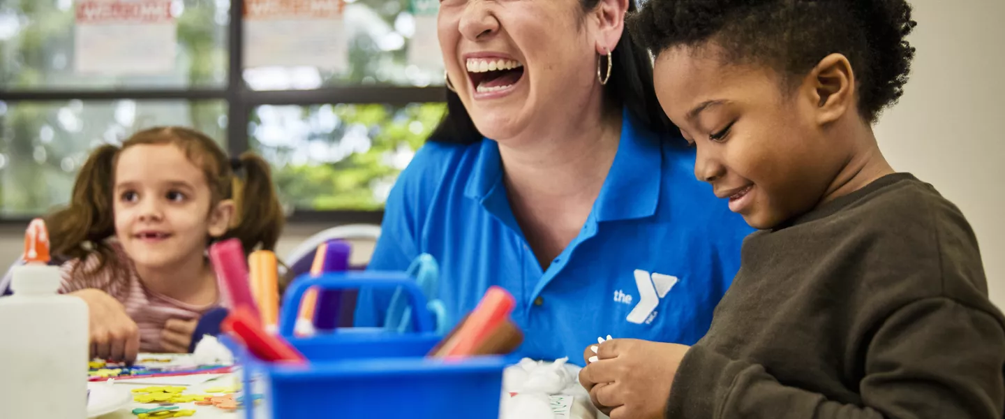 Afterschool staff laughing with kids