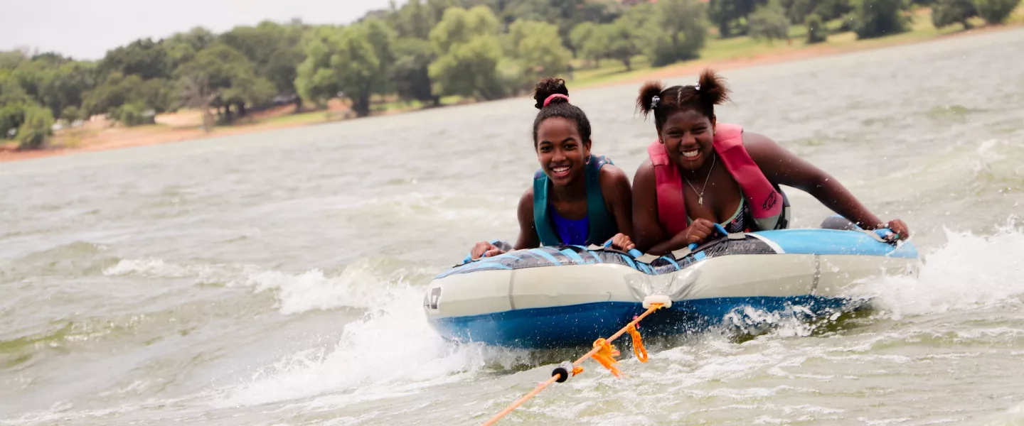 Two girls tubing on Lake Lewisville. 