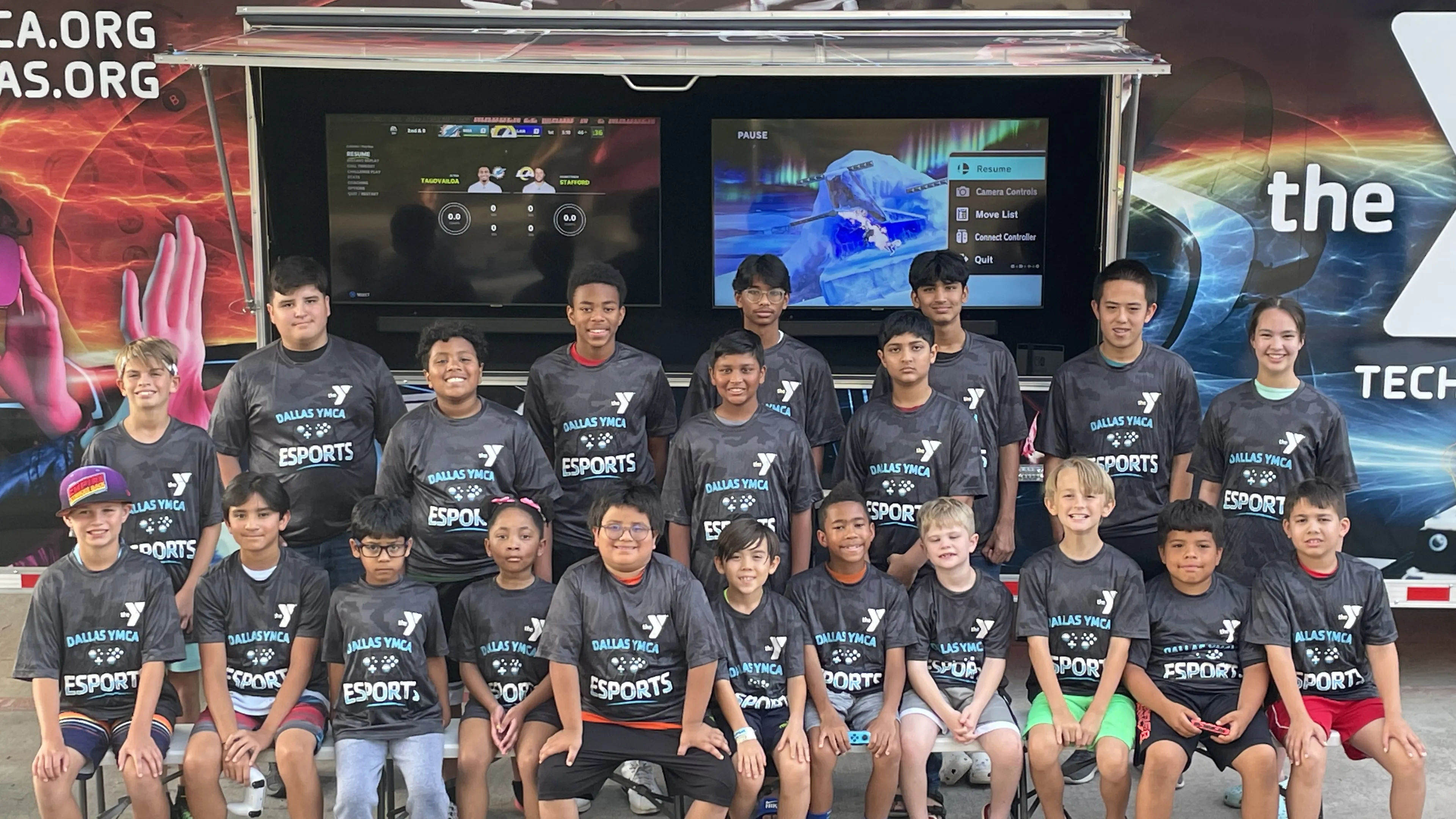 ymca esport team pose in front of gaming truck