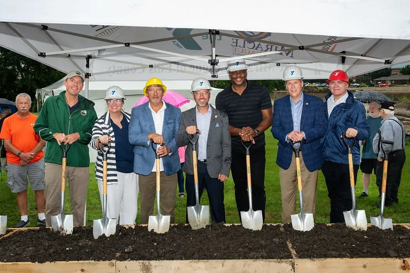 YMCA and local leadership with hard hats, posting for a groundbreaking photo