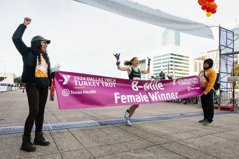 The 8-mile female winner about to run through the winner banner