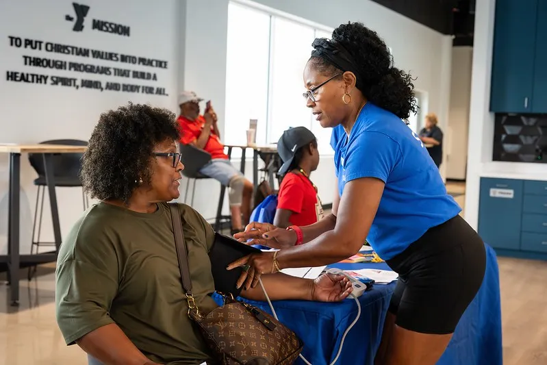 A woman getting her blood pressure checked at the Dallas YMCA Health Expo