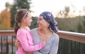 Mom who is a battling cancer holding her daughter
