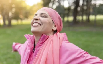 Istock photo- woman standing in the sunlight with arms open