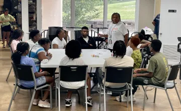 Teens sitting around a table learning about Mental Health